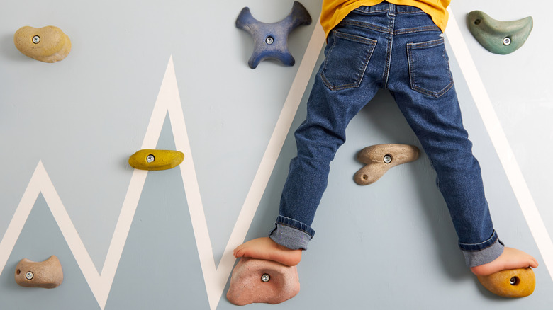 a child climbing on a home climbing wall