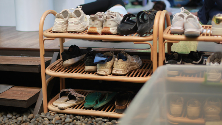Shoes on bamboo shoe racks near porch