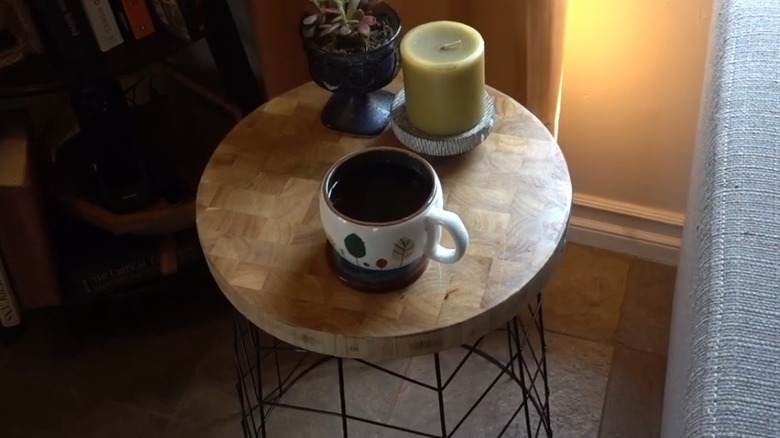 DIY end table with mug, candle, and plant