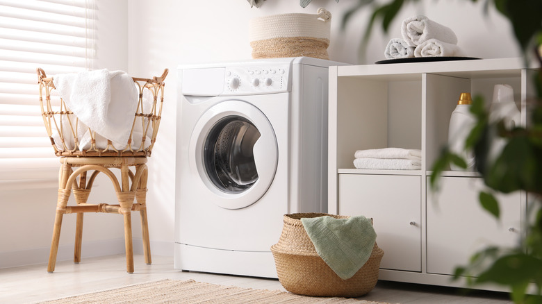 Laundry room with towels and a front-load washer