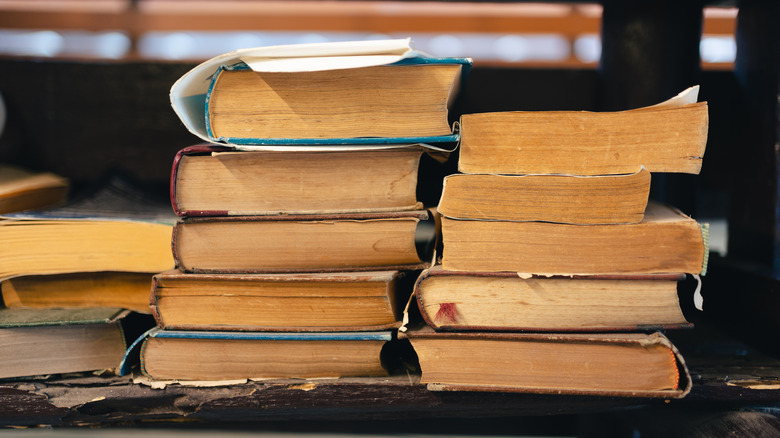 Stack of old books ready to be upcycled into a charming fall decor DIY