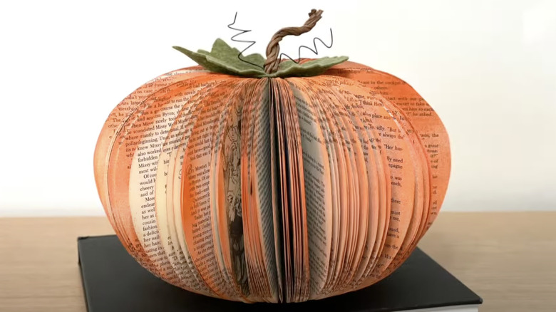 An old book is turned into a charming book pumpkin.