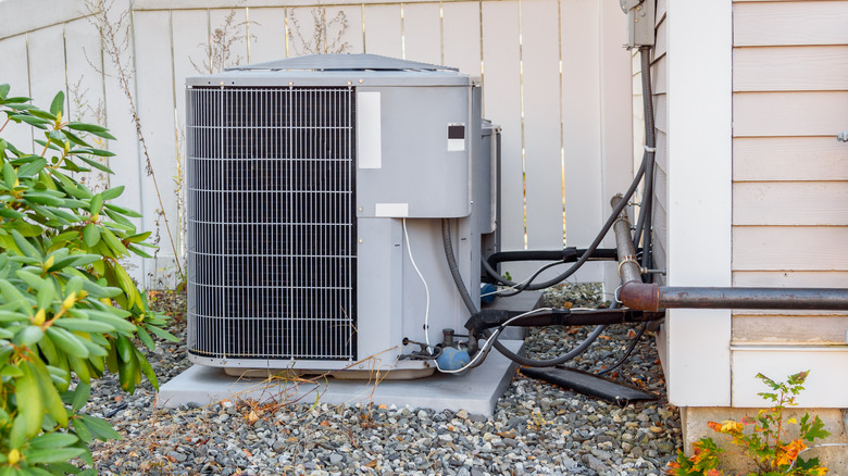 An outdoor air conditioner unit in a garden