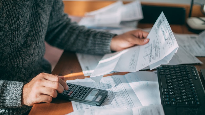 person using calculator calculating payments