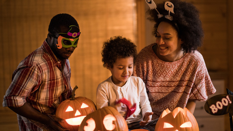 Family making pumpkin lights