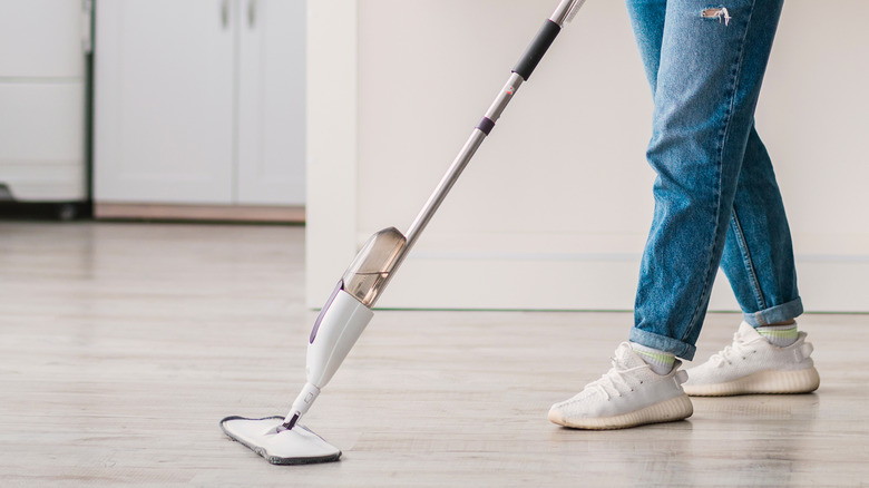 Person mopping laminate floor 