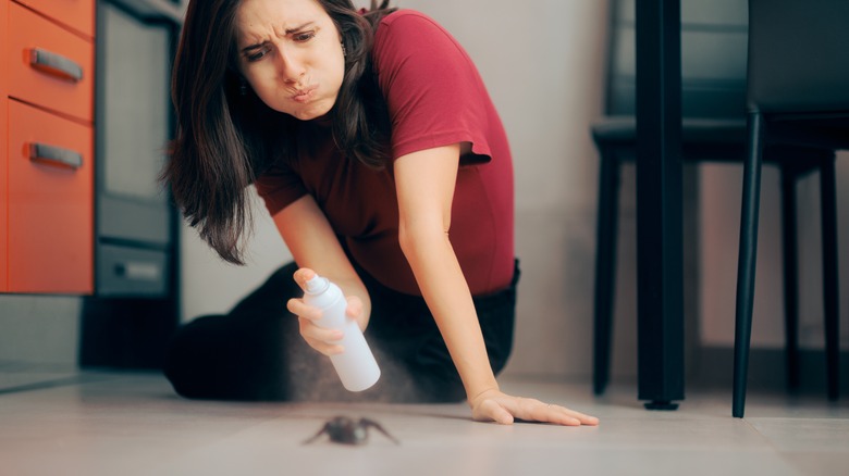 Woman spraying bug