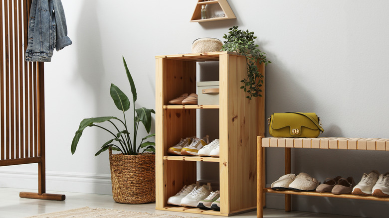 a modern entryway with shoe rack and coat stand