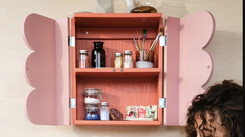 OMMJÄNGE cabinet with a shelf filled with various items