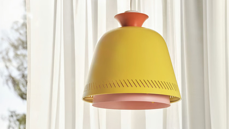 OMMJÄNGE pendant lamp shade hanging in a home