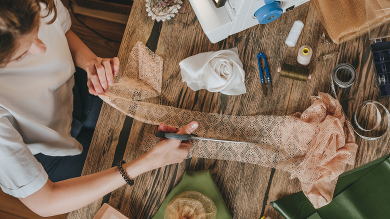 A woman cutting lace for a DIY project