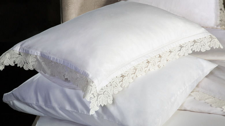 Closeup of lace-trimmed pillows with intricate detailing