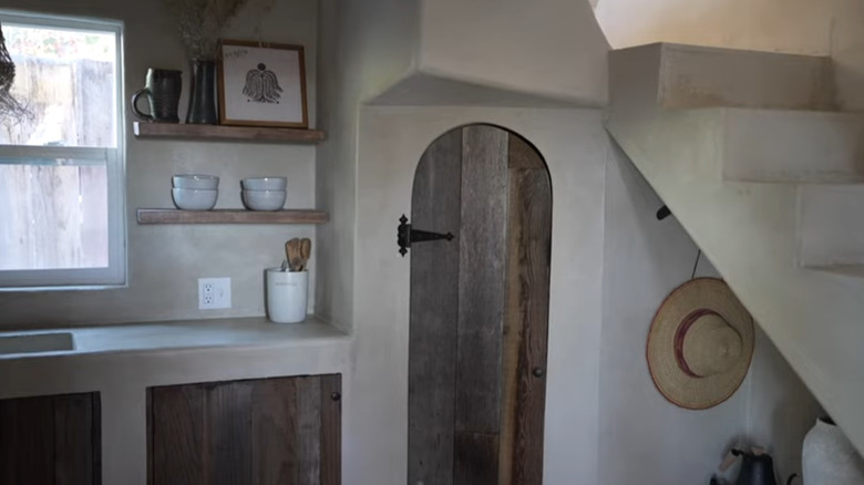 Kitchen with lime plaster countertop, walls, and stairs
