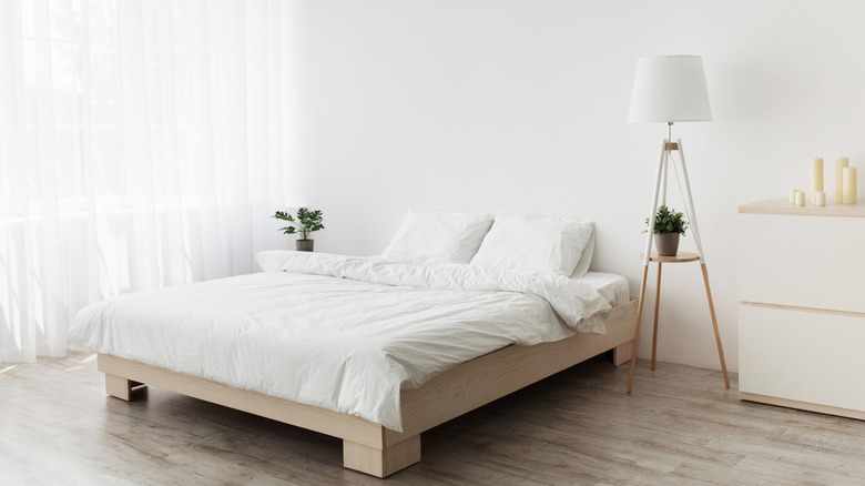 An all-white, minimalist bedroom.