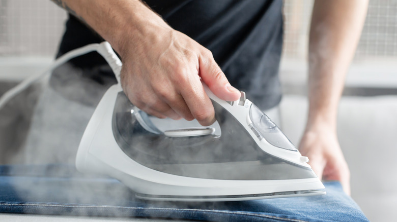 Person ironing a pair of jeans