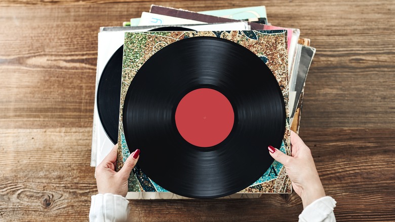 Person sorting through records stack