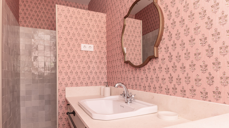Bathroom with white sink and floral pink wallpaper