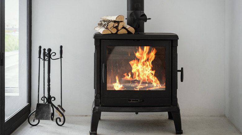 black fireplace with wood pile