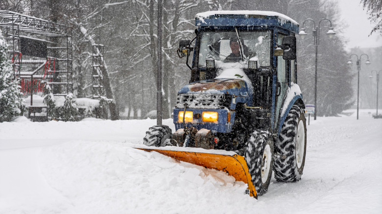 Small tractor plowing snow