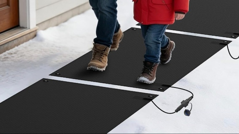 People walking across HETFOENT snow melting mats outside.