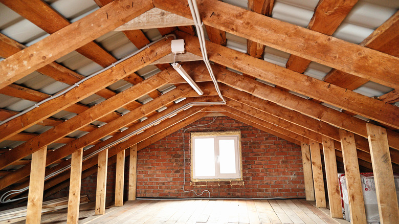 Interior view of an unfinished attic with wood beam construction