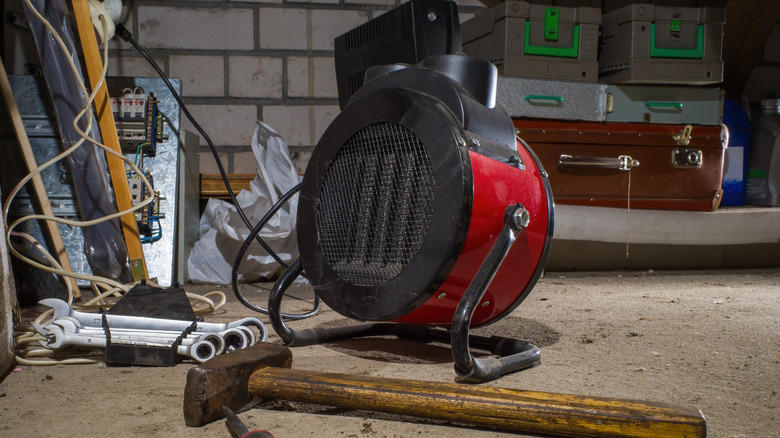 A portable electric forced-air heater in a garage