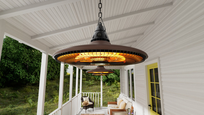 The Sundate patio heater hanging from a white patio ceiling
