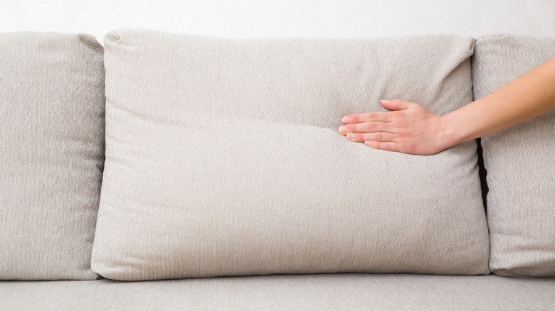 hand on couch cushions