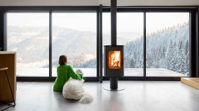 woman looking out winter windows