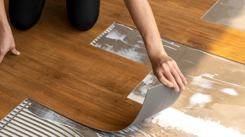 Person installing vinyl flooring