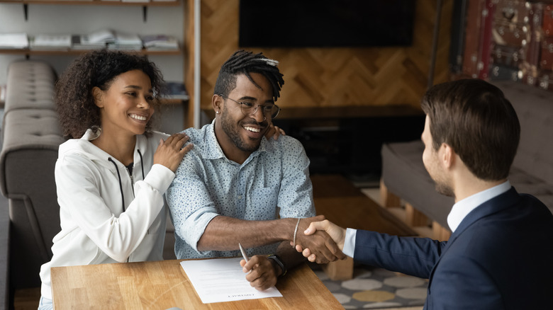 couple with real estate agent