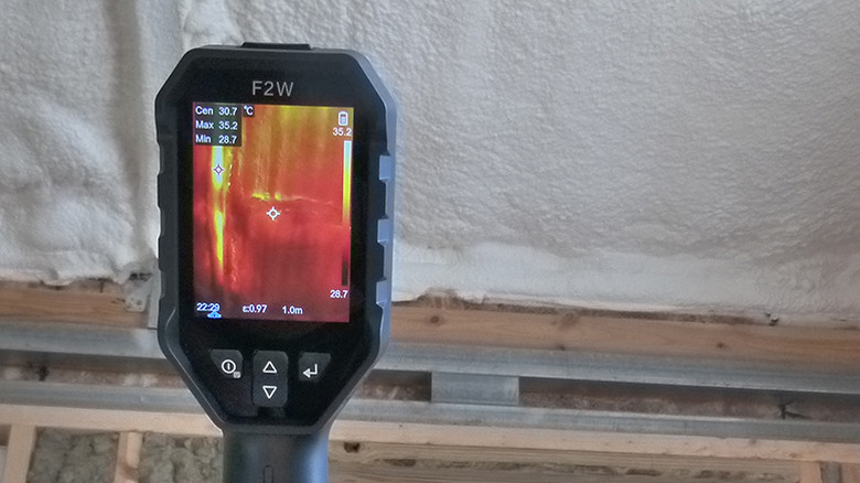Spray foam insulation and framing seen through the screen of an HSFTools F2W thermal camera