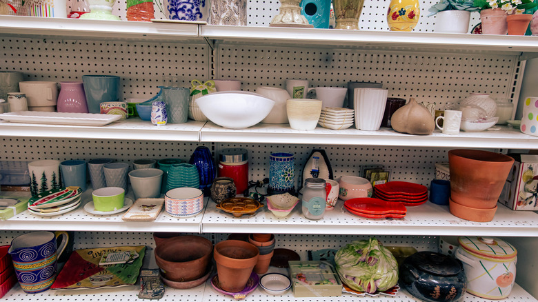 Lots of different vintage pottery and ceramic items for sale in a thrift store