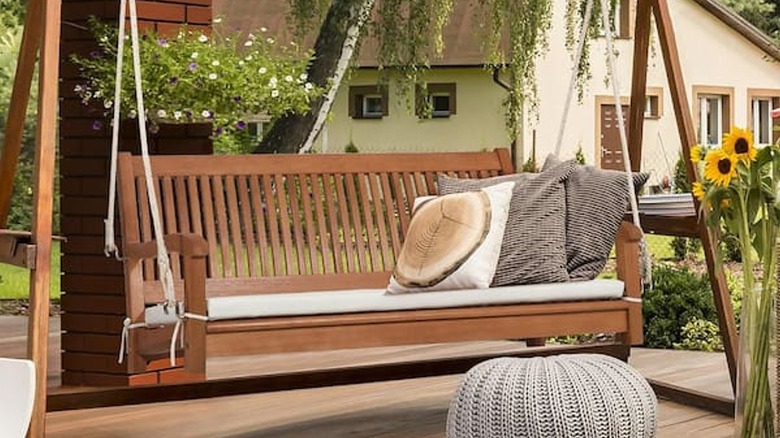 Wooden hanging porch swing on patio