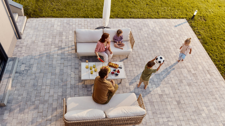 Family playing outside on sunny patio