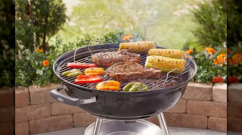 Charcoal grill with food cooking on it