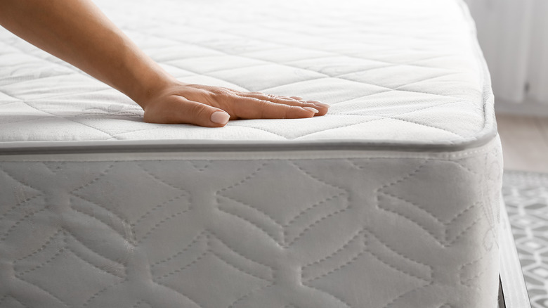 woman touching new mattress