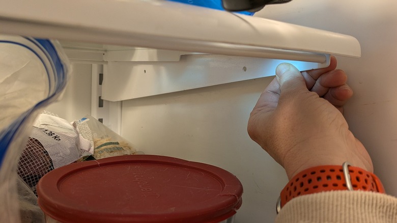 An Amana fridge shelf bracket