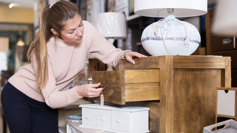 Someone inspecting furniture at a home decor store