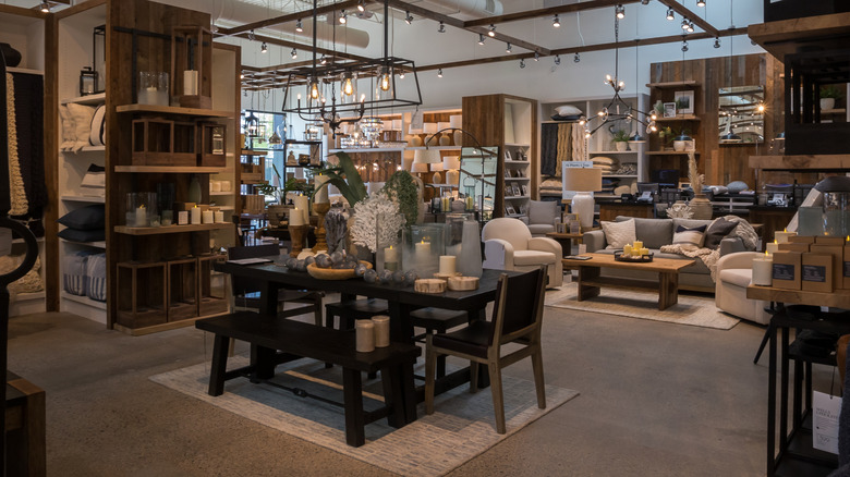 The inside of a Pottery Barn with wood furniture and decor