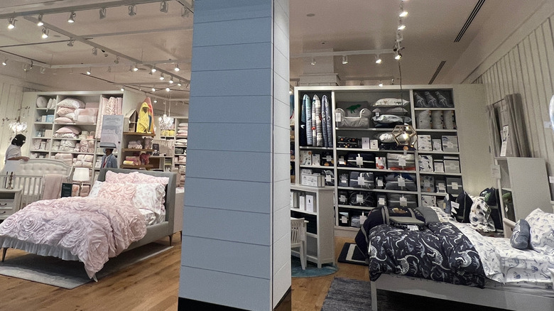 Pottery Barn Kids showroom floor displaying two beds and bedroom decor.