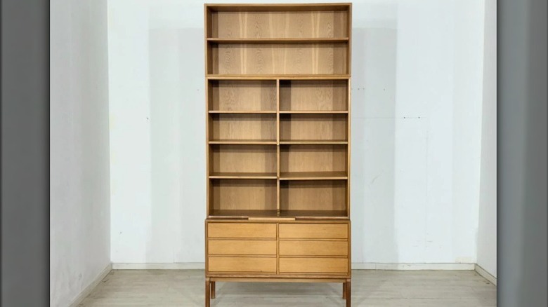 A large mid-century cabinet with bookshelves.