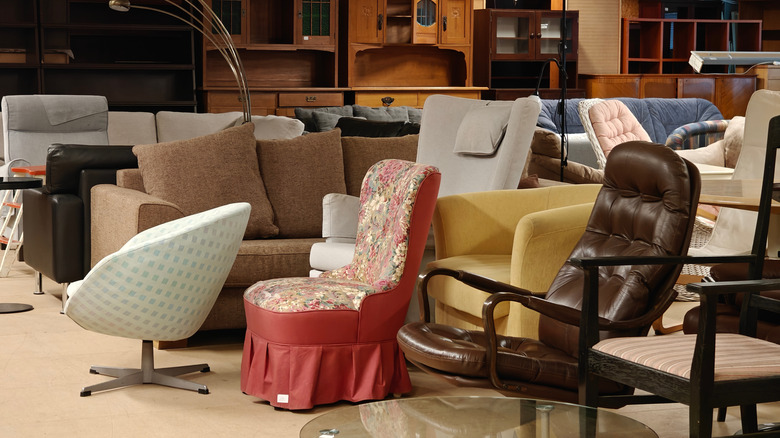 Various sofas and chairs in a thrift store