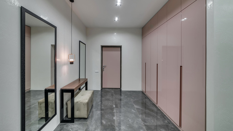 hallway with mirror on wall