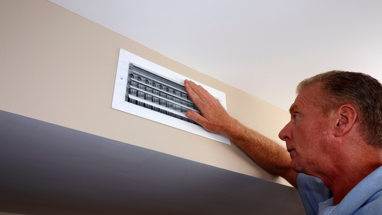 man opening air vent