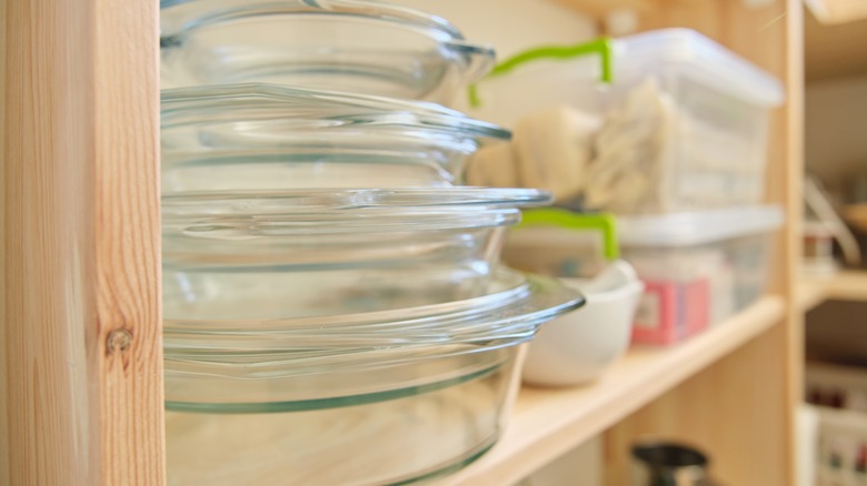 A cabinet with clear glass baking dishes