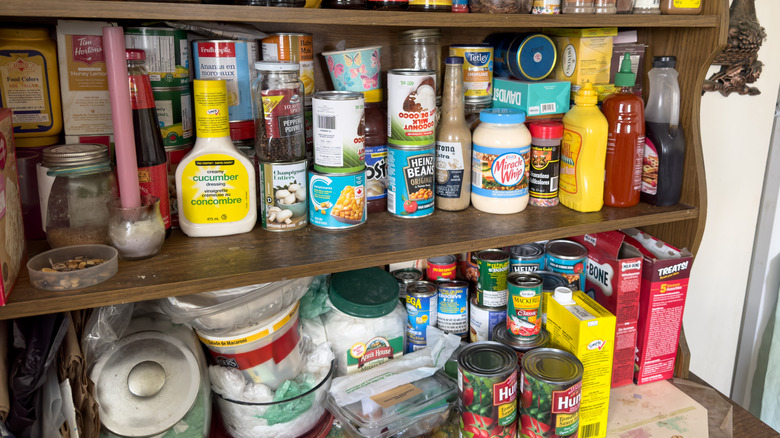 Full pantry shelves with a variety of foods on them.
