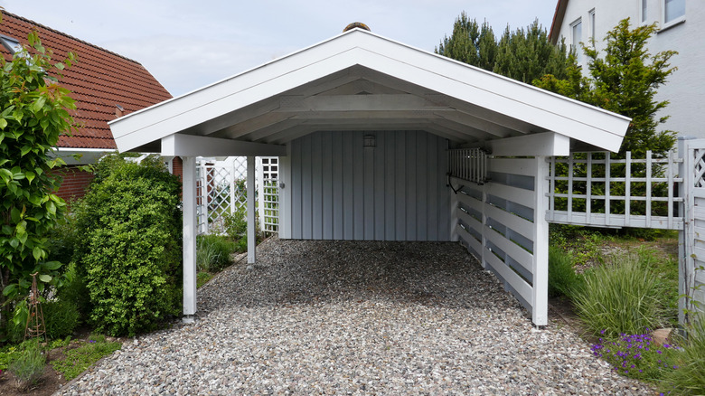 Gravel driveway leading to carport