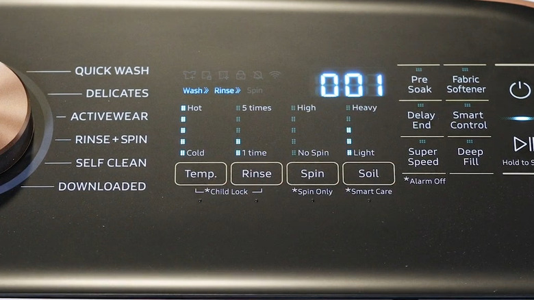 Closeup of a Samsung washing machine panel as wash, rinse, and 001 are lit up