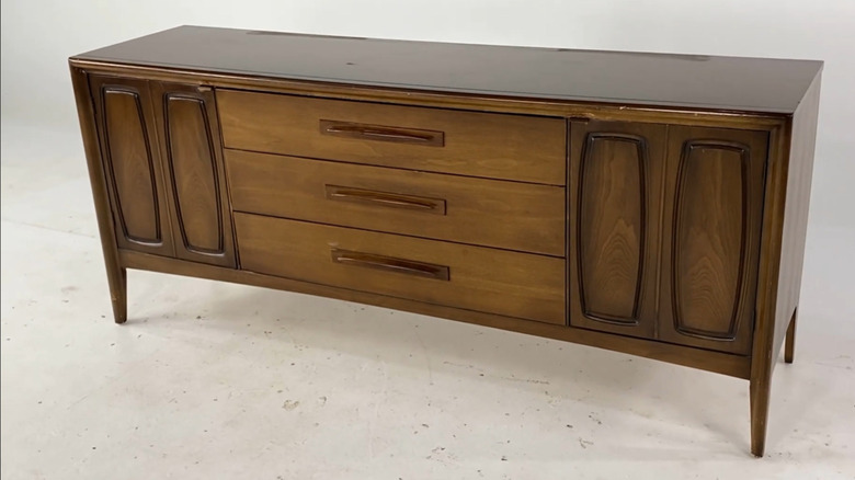 A Broyhill lowboy dresser in walnut sitting on a white background.